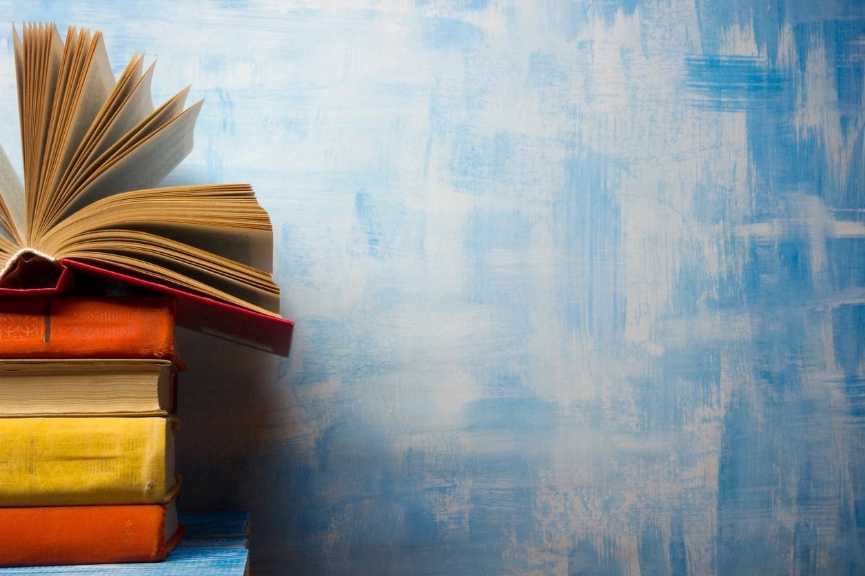 A stack of books on top of a table.