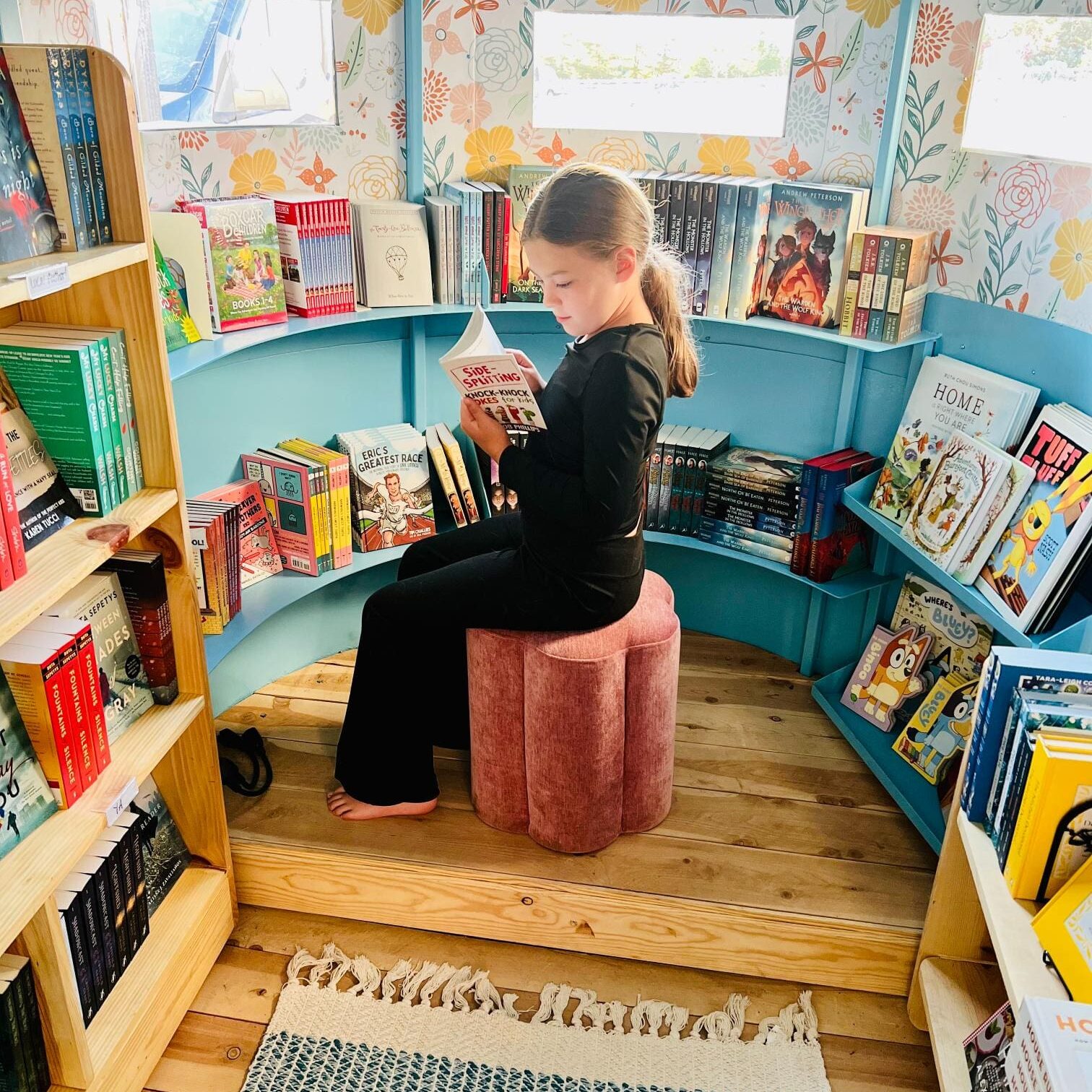 Child reading in colorful circular book nook